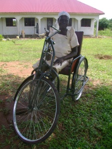 Gracie in her bicycle that can be operated by hand.